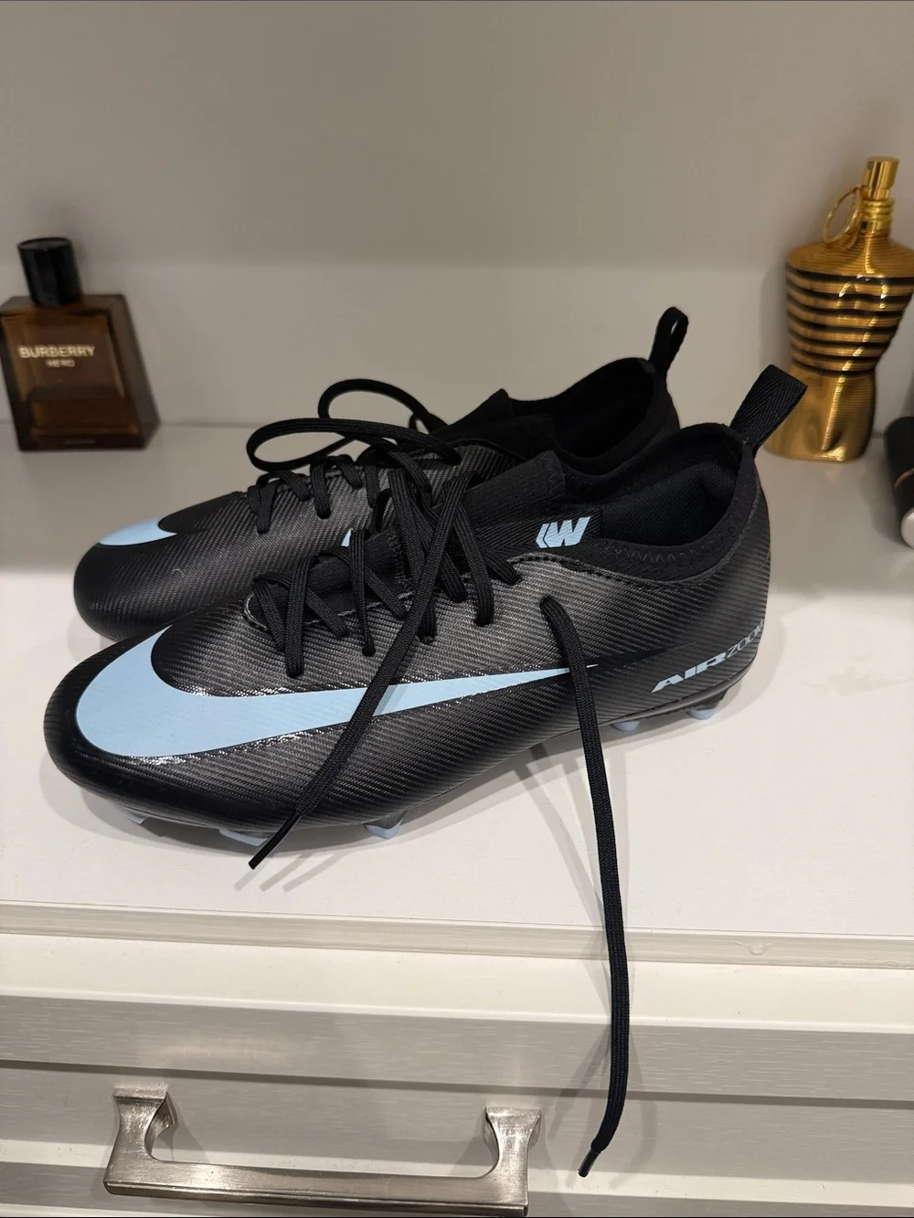 Nike Men’s Black Athletic Cleats with Light Blue Swoosh